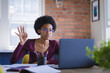 © Wavebreak Media - Teenage girl raising hand during online lecture on laptop at home