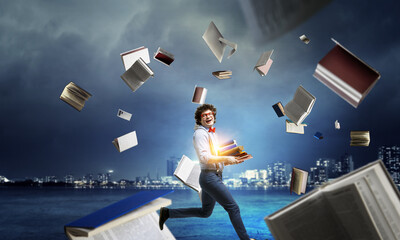 Wall Mural - World of books concept with a student