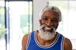 © Wavebreak Media - Portrait of happy african american senior man with white beard wearing blue vest at home