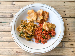 Wall Mural - red fried rice with fried noodles and side dish.