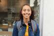 © Wavebreak Media - Portrait of smiling young african american woman with wireless headphones in city