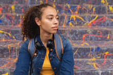 Beautiful African American Young Woman Looking Away Against Steps With Graffiti
