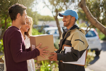 Canvas Print - Delivery right to your door. Shot of a courier delivering a package to a smiling young couple at home.