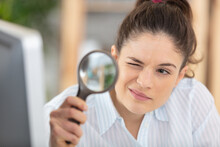 Business Woman Using Magnifying Glass To Check Contract
