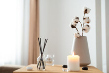 Scented Candles And Aroma Incense Sticks On Wooden Table In Living Room. Aromatherapy, Home Fragrance. Concept Of Home Relaxation And Anti Stress.