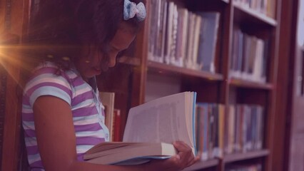 Sticker - Animation of light trails over biracial girl reading book