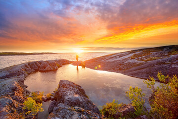 Wall Mural - stone shore of the lake at sunset