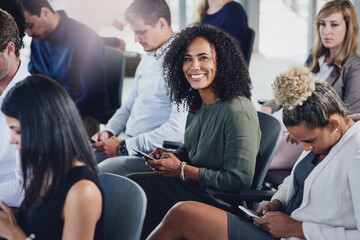 Poster - I always enjoy these seminars. High angle portrait of an attractive young businesswoman sitting in the conference room with her colleagues during a seminar.