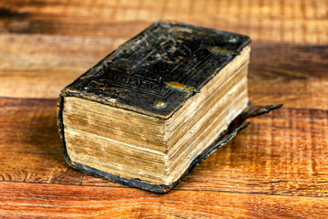 Big thick closed book on brown wooden table