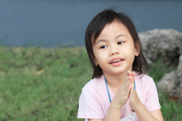 Wall Mural - Positive charming 4 years old cute baby Asian girl, little preschooler child smiling and looking to the left