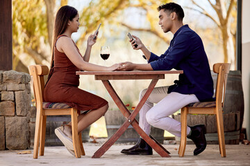 Poster - Baby, just a sec. I have to update my socials. Shot of a young couple having wine on a date on a wine farm.