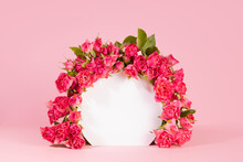 Delicate Summer Pink Spray Roses As Framing Of White Round Arch On Pink Abstract Scene Mockup, Copy Space. Template Floral Showcase For Presentation Of Cosmetic, Goods, Advertising, Design.