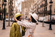 Cheerful Women In Hats In City