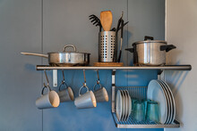 Shelves With Various Utensils And Dishware Hanging On Wall