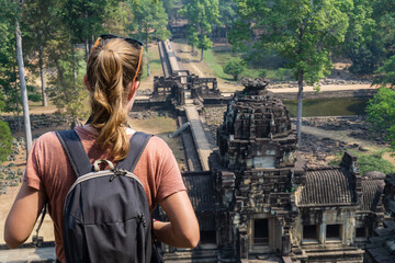 Young female tourist enjoying the views in Angkor Wat, Siem Reap, Cambodia.