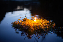 Wildflower Wreath With A Candle Floating On The River. Ivan Kupala, Kupala Traditions