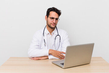 Wall Mural - hispanic handsome man feeling sad, upset or angry and looking to the side. physician concept