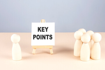 Poster - KEY POINTS text on easel with wooden figure, meeting concept