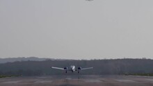 Long Shot Of A Twin Engined Light Aircraft Coming In To Land.