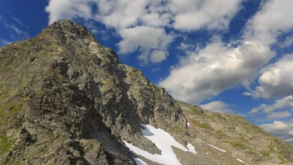 Wall Mural - mountain backbone on blue cloudy sky background time lapse scene