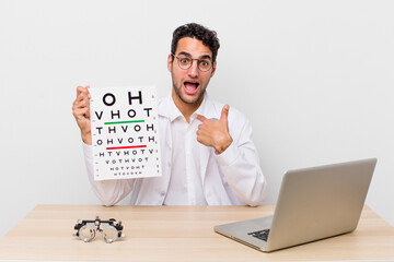 Poster - hispanic handsome man feeling happy and pointing to self with an excited. optical vision test concept