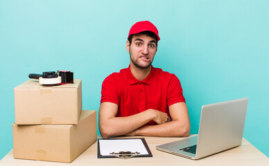 Wall Mural - hispanic handsome man looking puzzled and confused. packer employee concept