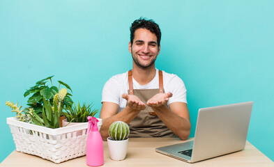 Wall Mural - hispanic handsome man smiling happily with friendly and  offering and showing a concept. garden and plants concept