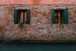 Traditional house windows on Venice channels seen through the alleys