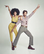 © Yuri Arcurs/peopleimages.com - Lets dance. An attractive young couple standing together in retro 70s clothing.