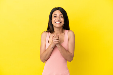 Wall Mural - Young caucasian woman isolated on yellow background laughing