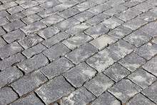 Gray Stone Pavement Texture, Cobbled Street. Old Paved Road With Tiles From Cobblestones