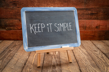 Sticker - keep it simple  inspirational reminder writing - white chalk on a slate blackboard, simplicity, minimalism and lifestyle concept