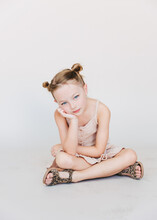 Cute Little Girl Looking Bored, In Front Of A White Background