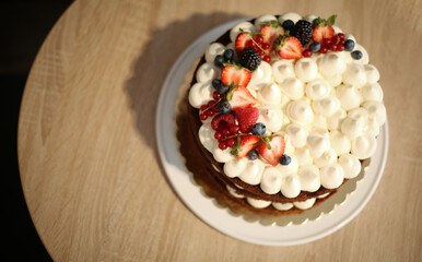 Poster - Top view of fresh tasty cake with berries and fruits on a wooden table