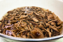 Closeup Of Agrocybe Cylindracea Edible Dried Mushrooms Soaking In The Water Before Cooking