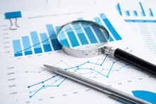 Magnifying Glass On Charts Graphs Paper. Financial Development, Banking Account, Statistics, Investment Analytic Research Data Economy, Stock Exchange Trading, Business Office Company Meeting Concept.