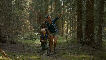 Wall Mural - family with small children walking in summer forest.
