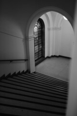 Poster - Vertical shot of a stone staircase framed by an arched white doorway