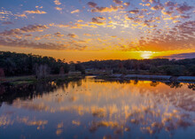 Scenic View Of A Sunset Reflecting In The Lake At Langan Park In Mobile, Alabama