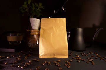 Poster - Closeup shot of a coffee bag with pour over maker and kettle on background