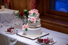 Closeup Shot Of The Traditional Three Floors White Wedding Cake With Pink Roses