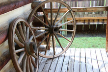 Closeup Of Old Fashion Wagon Wheels Propped Up Against A Log Cabin At Fort Christmas, Florida