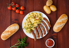 Top View Of Nuremberg Sausages With Potato Salad On A Wooden Surface