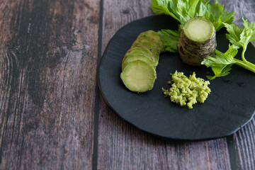 Sticker - Plate of Japanese horseradish or wasabi on a wooden table