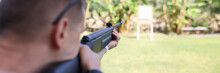 Man Shooting Gun At Target On Vacation Closeup