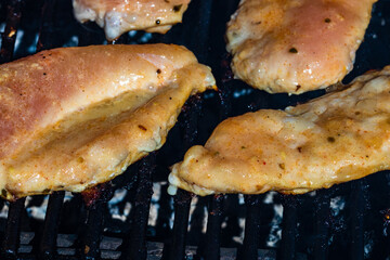 Canvas Print - Raw steak on a charcoal barbeque. Top view of camping tasty barb