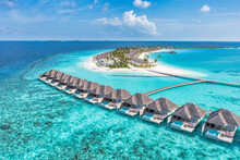 Maldives Paradise Island. Tropical Aerial Landscape, Seascape With Jetty, Water Bungalows Villas With Amazing Sea Lagoon Beach. Exotic Tourism Destination, Summer Vacation Background. Aerial Travel