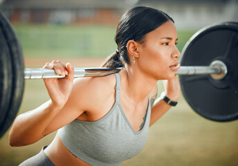 Wall Mural - Lifting her spirits. Cropped shot of an attractive young female athlete exercising with weights outdoors.