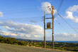 new modern overground wooden low voltage power line pole with electric transformer in rural area