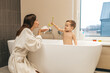 © zinkevych - Mother playing with her baby boy in the bathroom